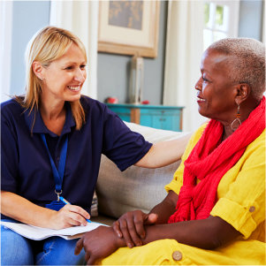 caregiver talking to senior woman while taking notes