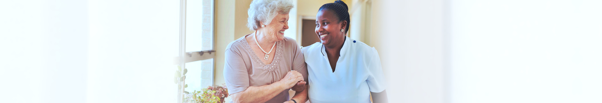 caregiver and senior woman walking