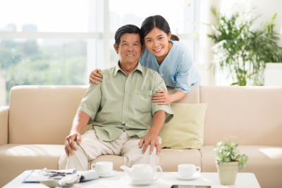 caregiver hugging senior man