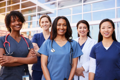 Female healthcare colleagues standing outside hospital